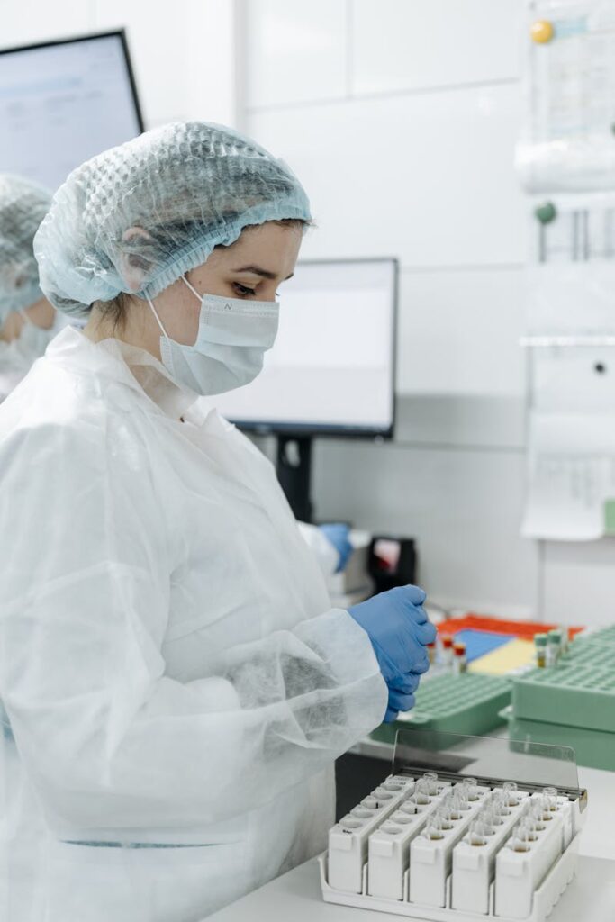 Female lab technician working with samples in a sterile laboratory environment.